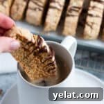 25 Sourdough Breakfast Ideas: 25+ Recipes for Morning Bread Dishes 5 Sourdough almond biscotti being dipped in a cup of coffee.