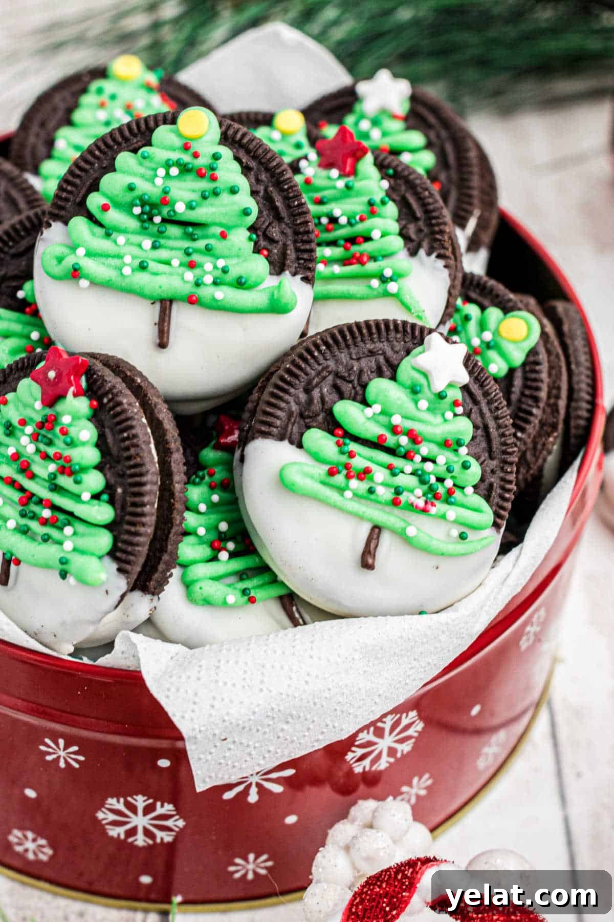 Festive Christmas Oreo Cookie Recipes for Holiday Baking 2 Side view of a tin of Christmas oreo cookies with a christmas tree.