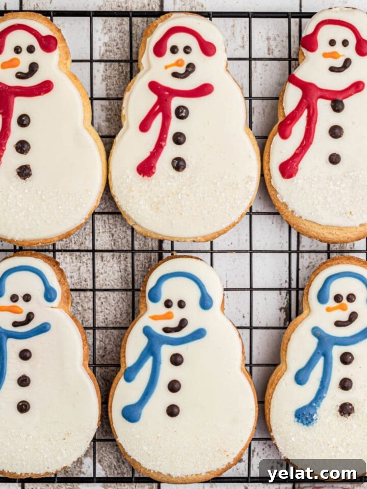 Festive Christmas Oreo Cookie Recipes for Holiday Baking 8 Copycat Starbucks snowman cookies lined up on a cooling rack.