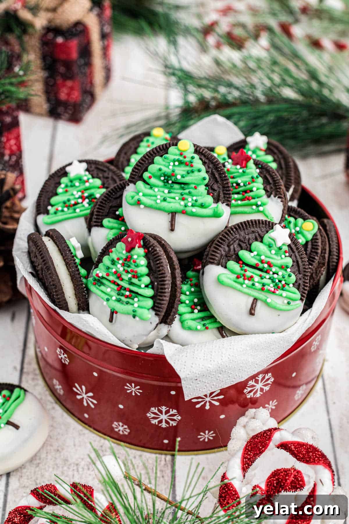 Festive Christmas Oreo Cookie Recipes for Holiday Baking 9 Beautifully arranged tin of christmas oreo cookies with christmas trees.