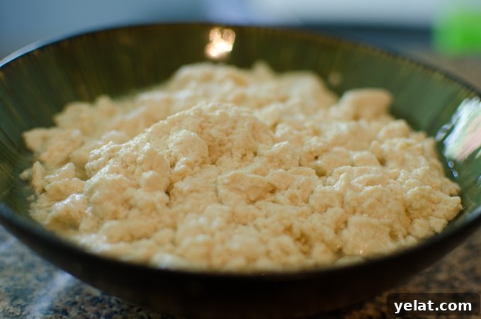 Tomato, Egg & Tofu Stir-Fry: Quick Savory Weeknight Recipe 3 Soft tofu is crumbled in a bowl.