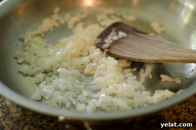 Tomato, Egg & Tofu Stir-Fry: Quick Savory Weeknight Recipe 4 Onion is cooked in a skillet until soft and translucent.