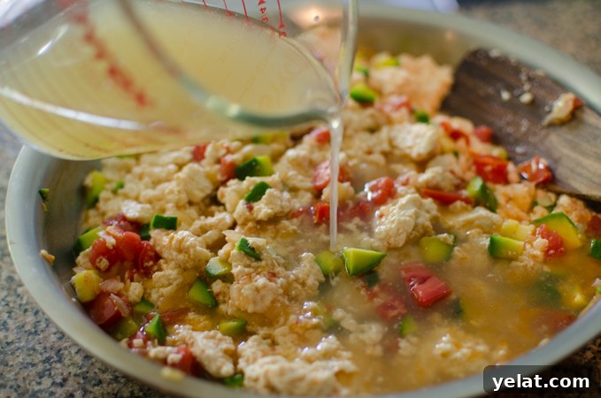 Tomato, Egg & Tofu Stir-Fry: Quick Savory Weeknight Recipe 6 Chicken stock is added to Korean soft tofu with zucchini and tomato mixture.