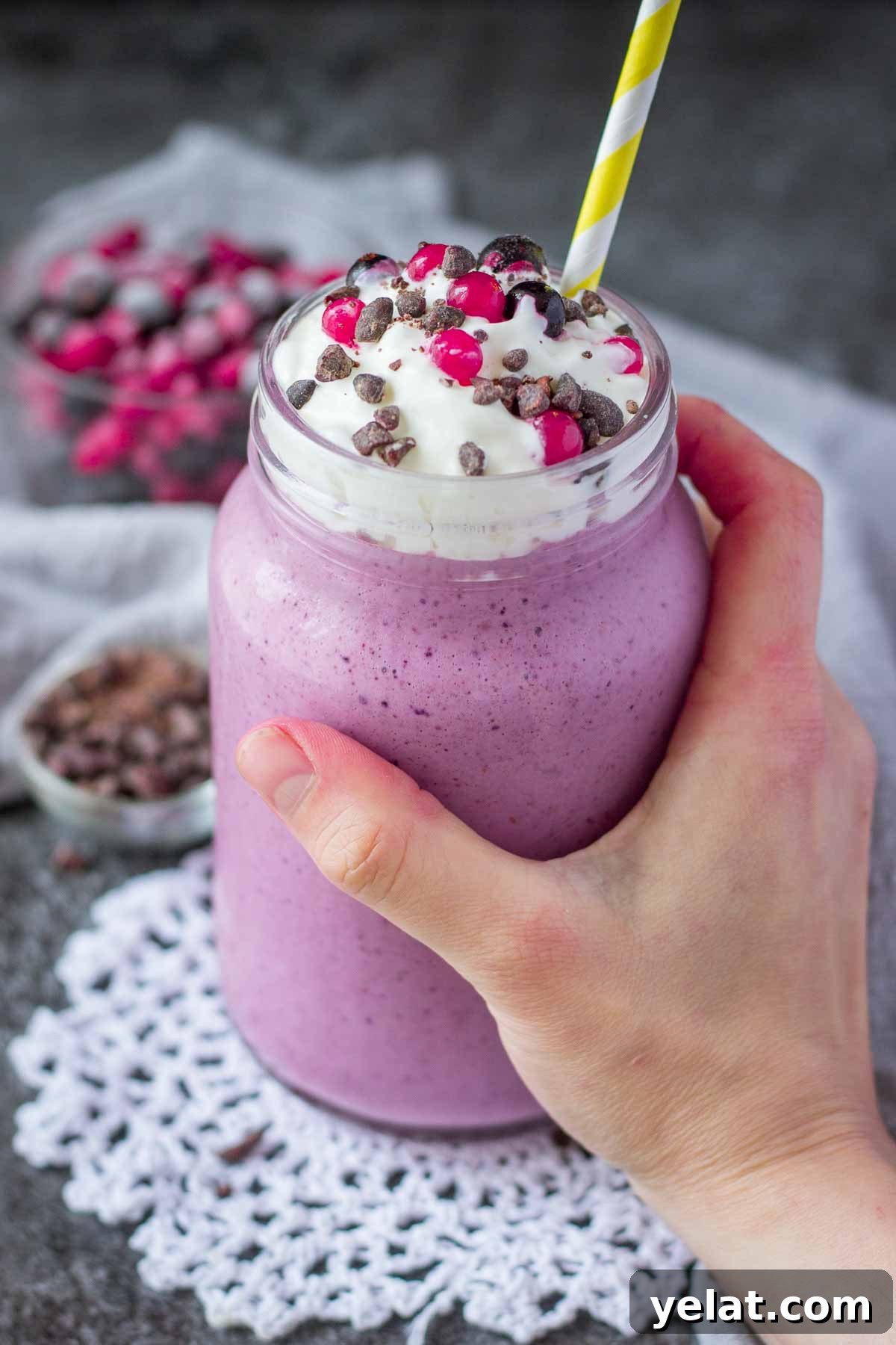 Creamy Mixed Berry Smoothie Recipe for Energy and Taste 6 Hand holding a glass full of frozen berry smoothie