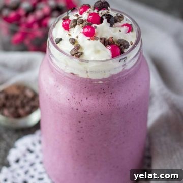 Creamy Mixed Berry Smoothie Recipe for Energy and Taste 8 Mixed Berry Smoothie topped with cream served in a glass with a straw