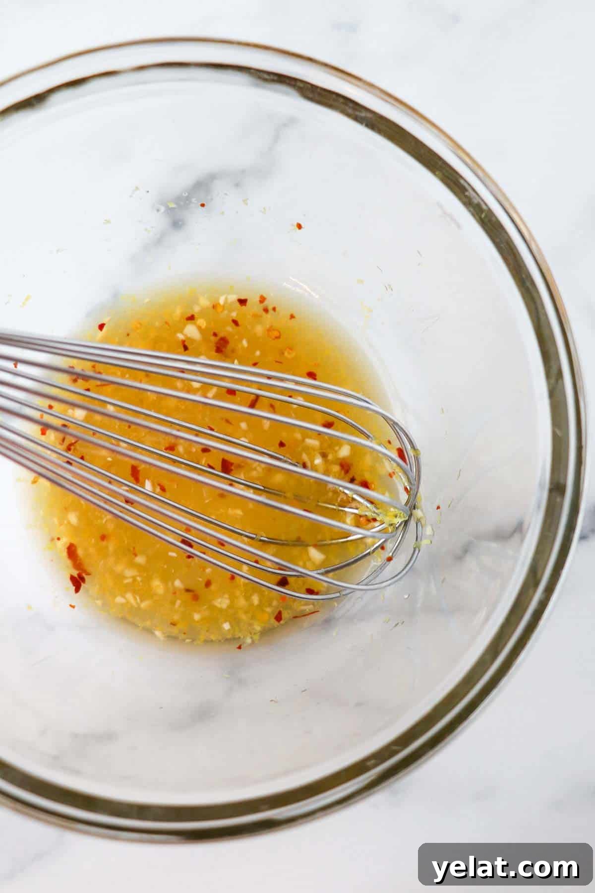 Quick Pickled Mushrooms: Fast Tangy Recipe for Snacks and Sides 6 Brine for quick pickled mushrooms in a glass bowl with a whisk.