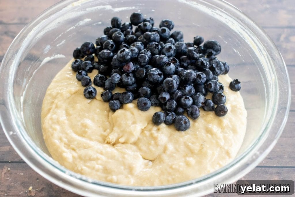 Moist Dairy-Free Blueberry Muffins Recipe 8 berries on top of batter