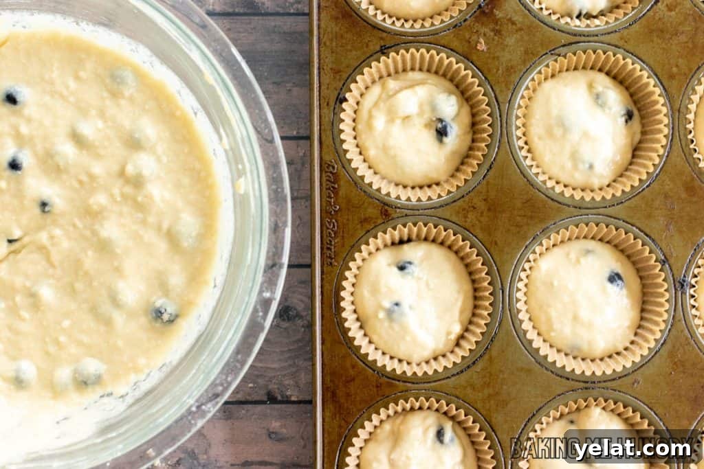Moist Dairy-Free Blueberry Muffins Recipe 9 batter in bowl next to pan with batter in paper liners