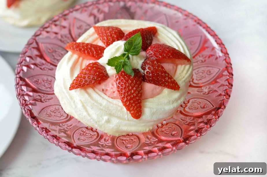 Light and Creamy Strawberry Mousse Pavlovas Recipe 3 single strawberry pavlova on pink crystal dish